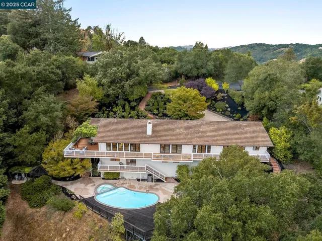 an aerial view of a house with a yard and garden