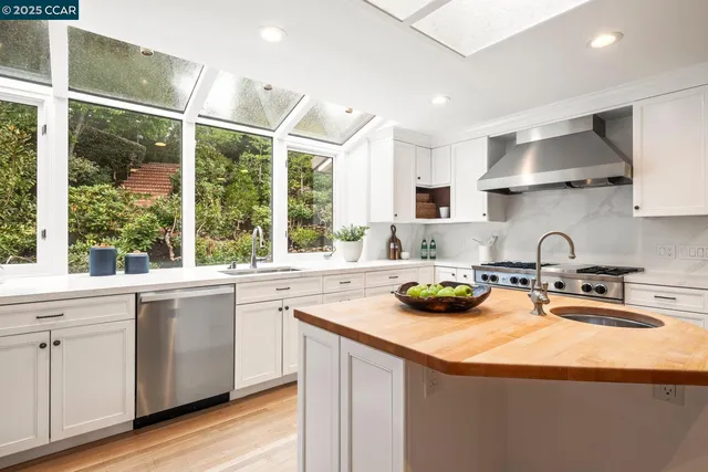 a kitchen with a sink a stove and cabinets