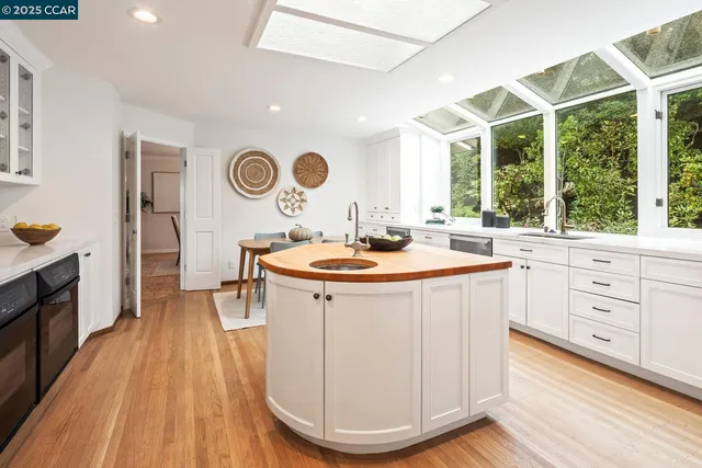 a kitchen with a sink and wooden floor
