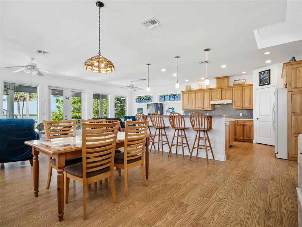 206 South Riverside Drive Edgewater, FL 32132 - Photo 19 of 60 a view of a dining room and livingroom with furniture wooden floor a chandelier