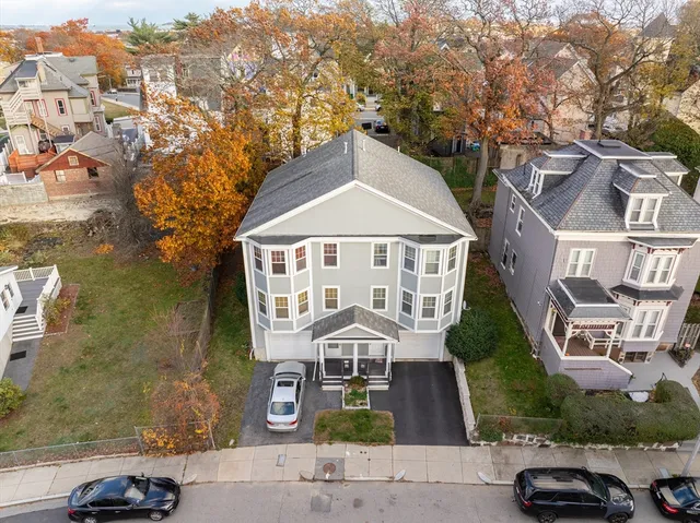 an aerial view of a house next to a road