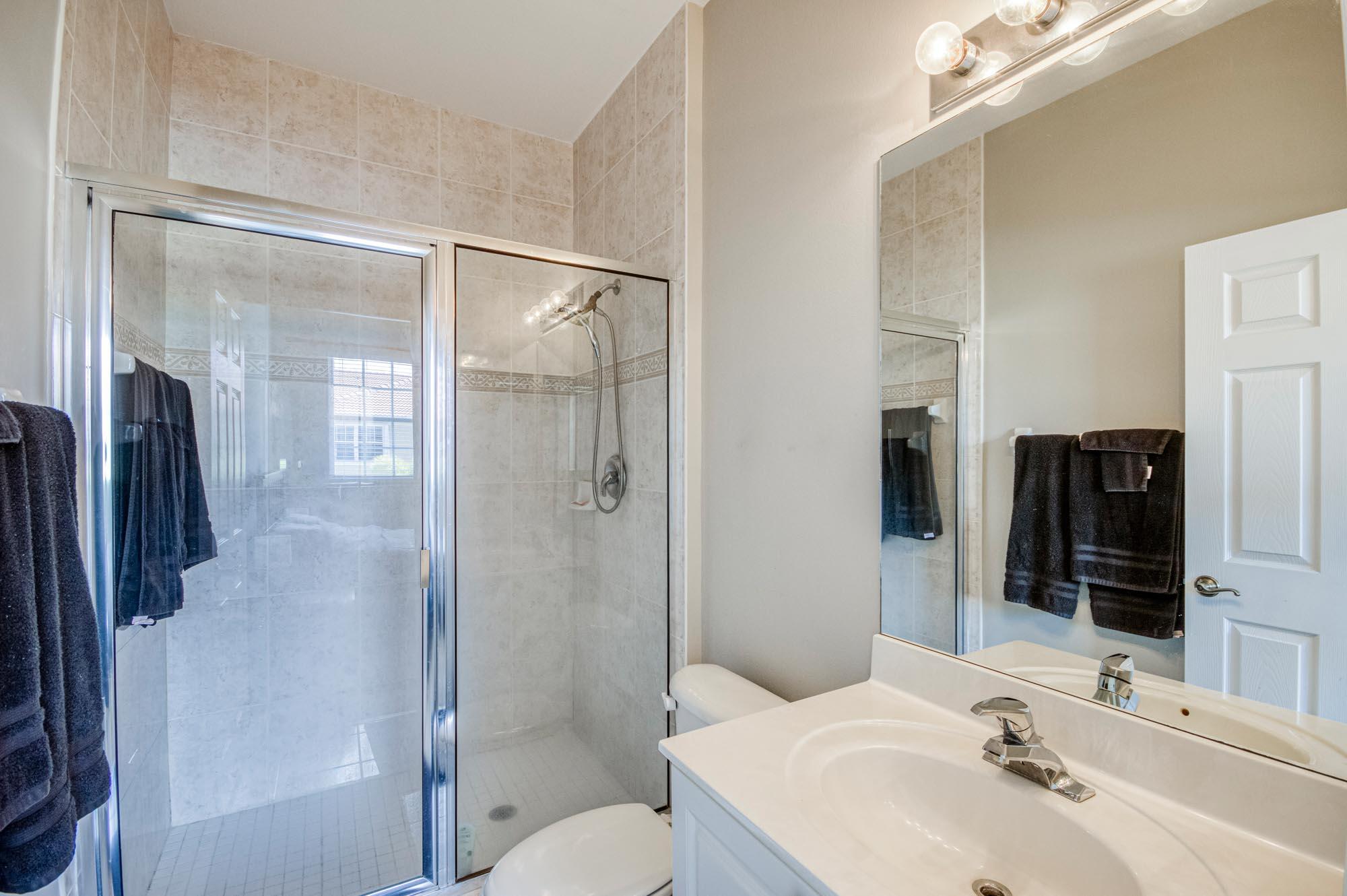 112 Lighthouse Circle, Unit J Tequesta, FL 33469 - Photo 14 of 22 a bathroom with a sink toilet and shower