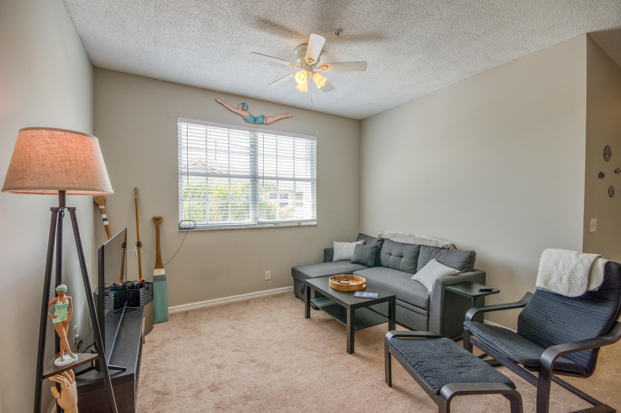 112 Lighthouse Circle, Unit J Tequesta, FL 33469 - Photo 6 of 22 a living room with furniture and a window