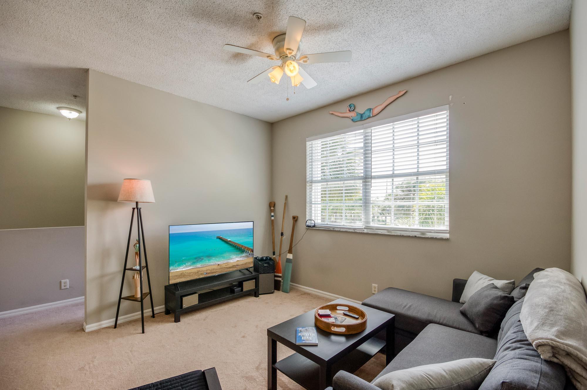 112 Lighthouse Circle, Unit J Tequesta, FL 33469 - Photo 7 of 22 a living room with furniture a air conditioner vent and a window