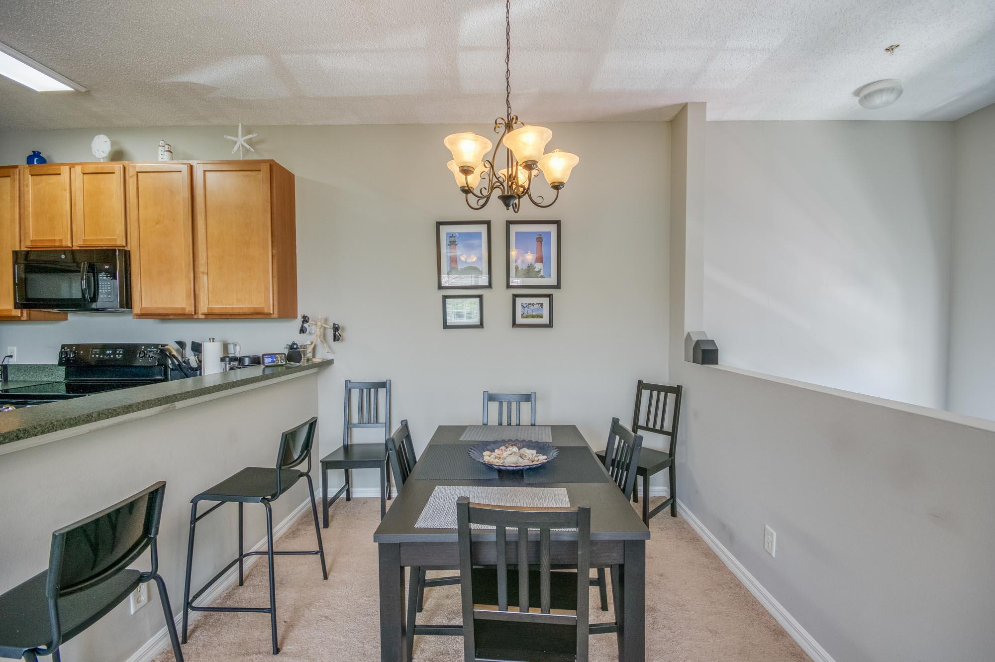 112 Lighthouse Circle, Unit J Tequesta, FL 33469 - Photo 9 of 22 a view of a dining room with furniture window and wooden floor