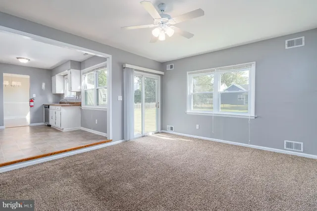 a view of livingroom with hardwood floor and a ceiling fan