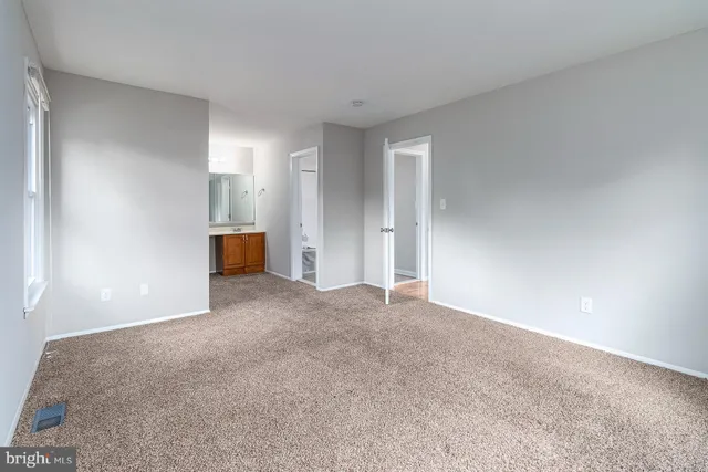 a view of an empty room and a window