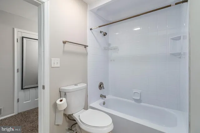 a bathroom with a toilet and a bathtub