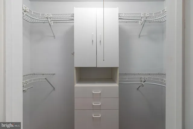a bathroom with a shower and cabinets