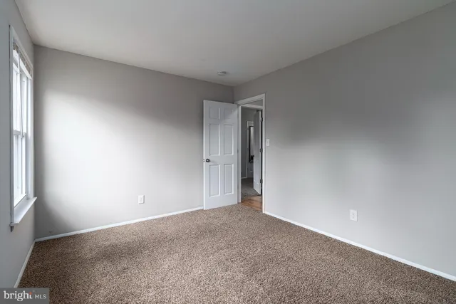 a view of an empty room and a window