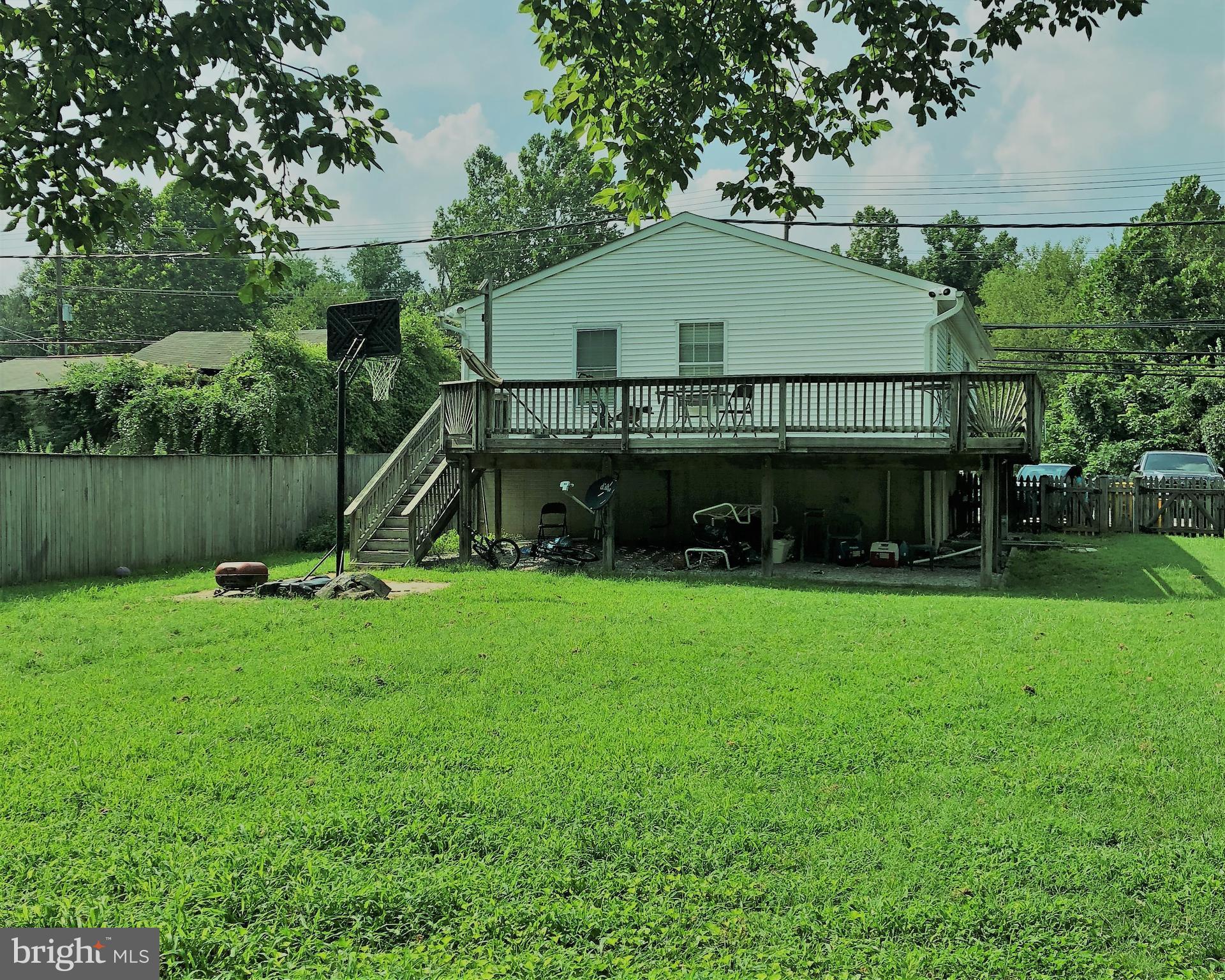 8121 Hog Neck Road Pasadena, MD 21122 - Photo 2 of 8 a view of a house with a yard and a slide
