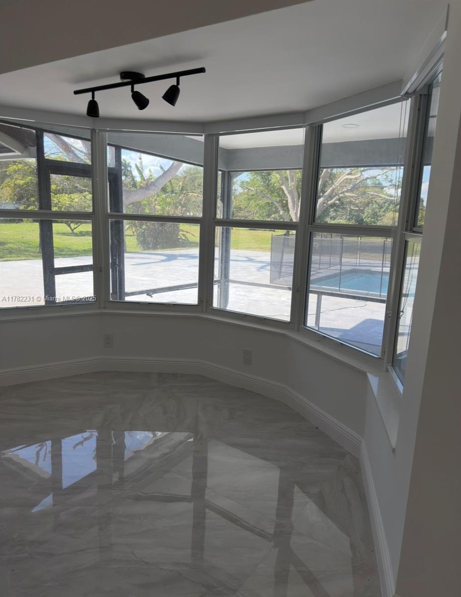 16911 Southwest 66th Street Southwest Ranches, FL 33331 - Photo 29 of 70 a living room with hardwood floor and a large window