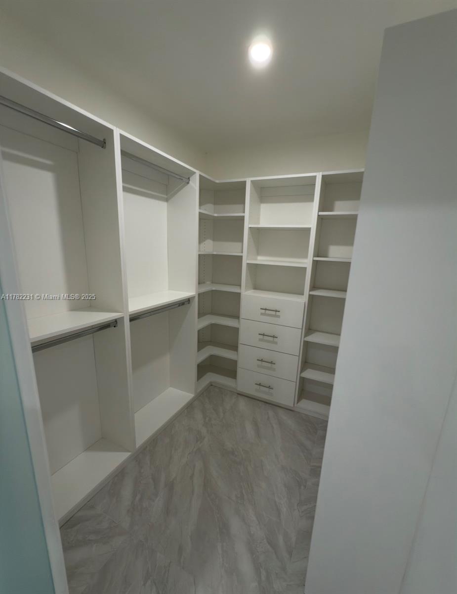 16911 Southwest 66th Street Southwest Ranches, FL 33331 - Photo 46 of 70 a view of walk in closet with empty racks