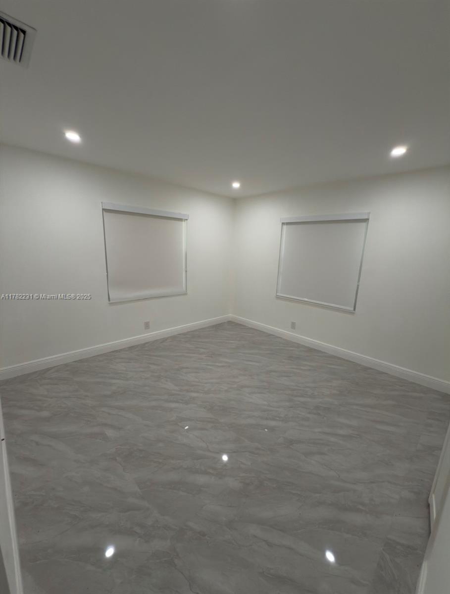 16911 Southwest 66th Street Southwest Ranches, FL 33331 - Photo 51 of 70 an empty room with wooden floor and windows