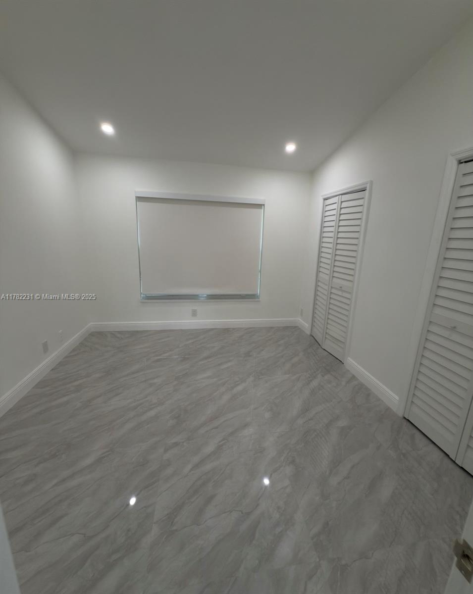 16911 Southwest 66th Street Southwest Ranches, FL 33331 - Photo 54 of 70 an empty room with wooden floor and windows