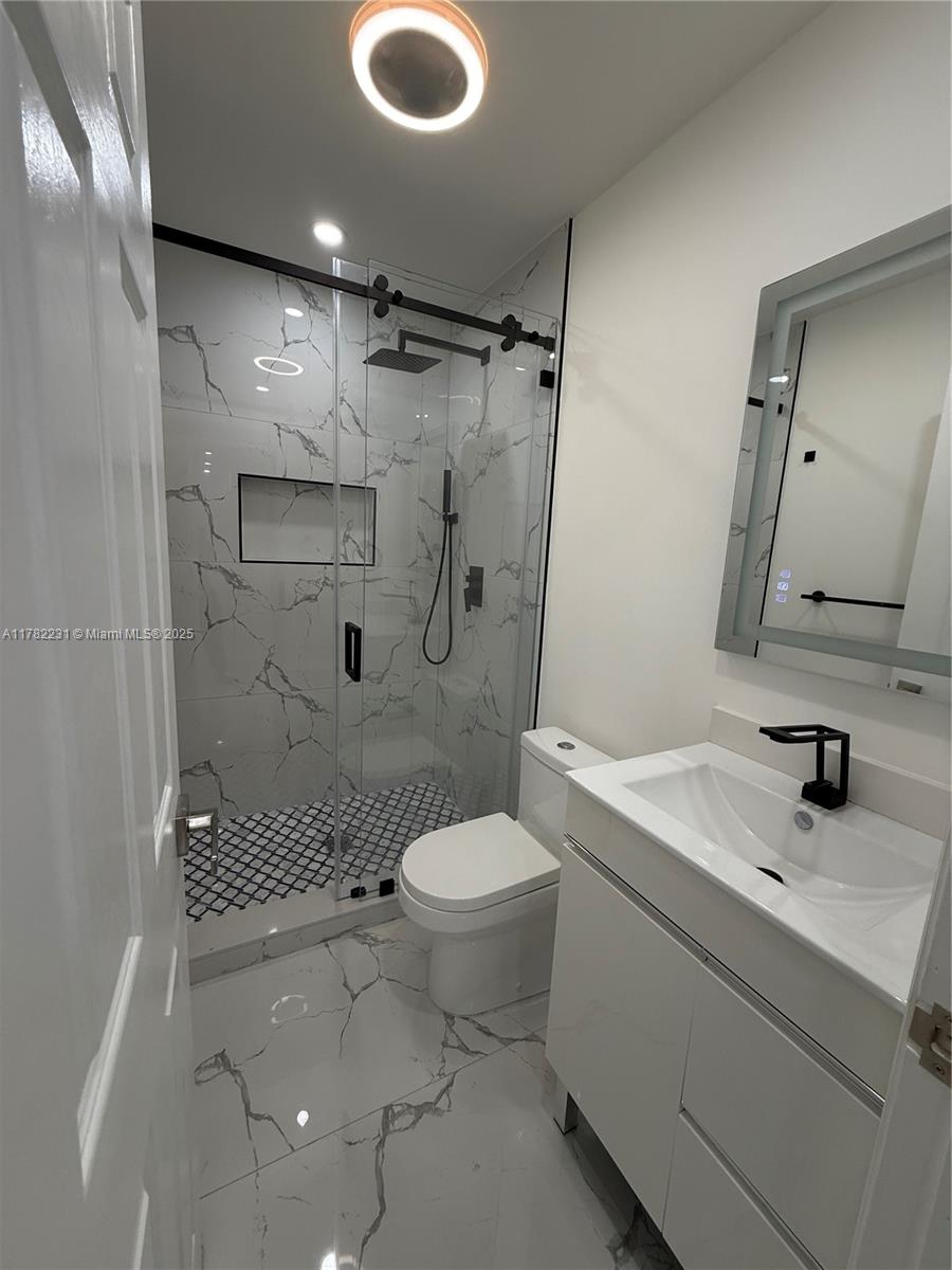 16911 Southwest 66th Street Southwest Ranches, FL 33331 - Photo 56 of 70 a bathroom with a sink toilet and shower