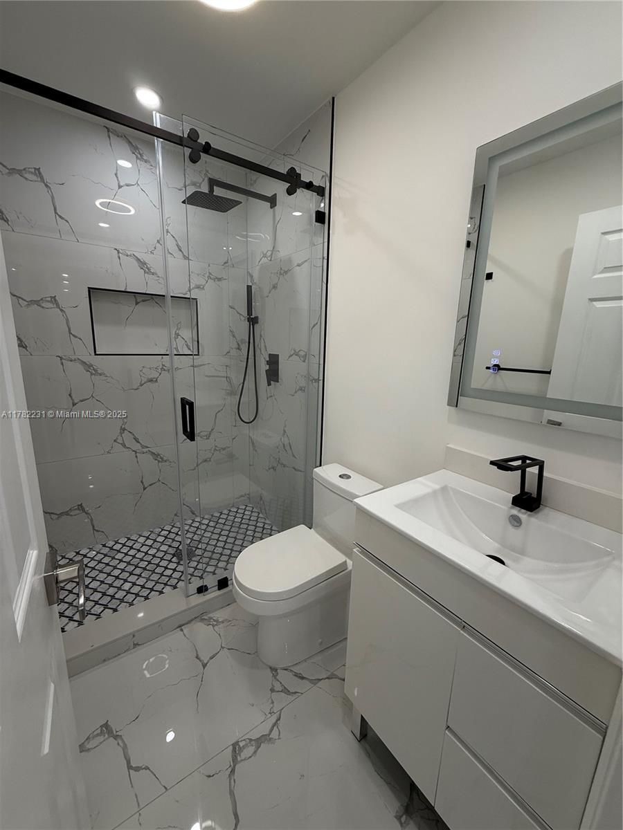 16911 Southwest 66th Street Southwest Ranches, FL 33331 - Photo 57 of 70 a bathroom with a sink toilet and shower