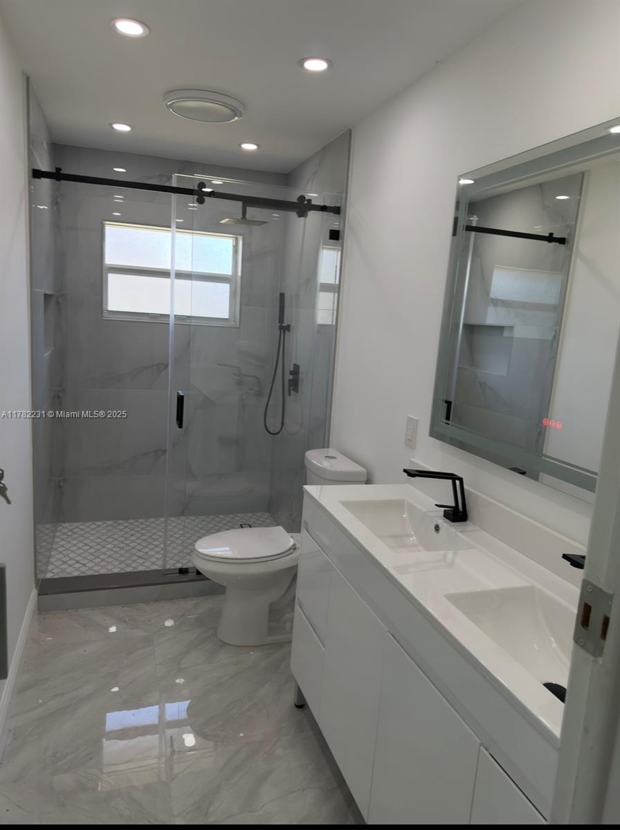 16911 Southwest 66th Street Southwest Ranches, FL 33331 - Photo 58 of 70 a bathroom with a sink toilet and shower