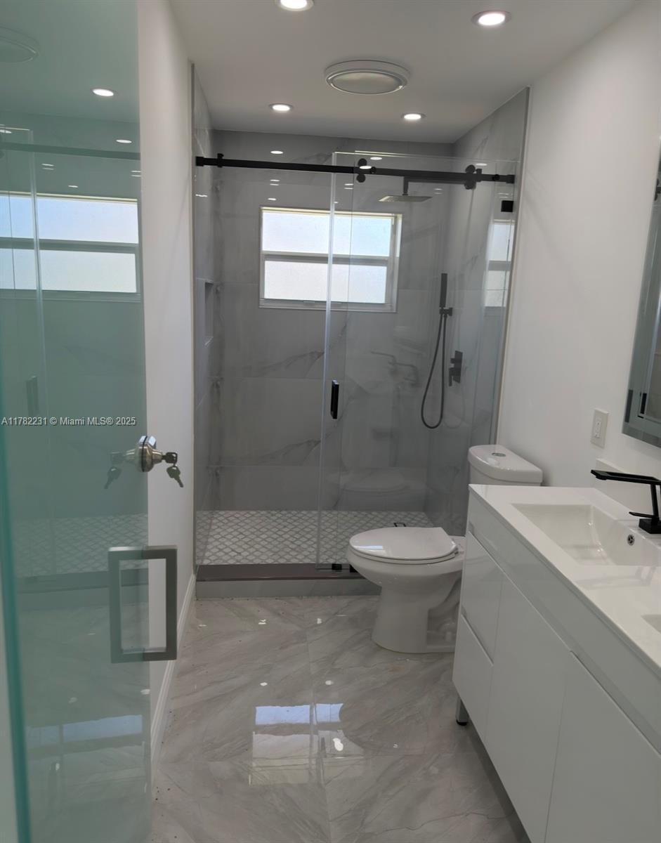 16911 Southwest 66th Street Southwest Ranches, FL 33331 - Photo 59 of 70 a bathroom with a toilet a sink and shower