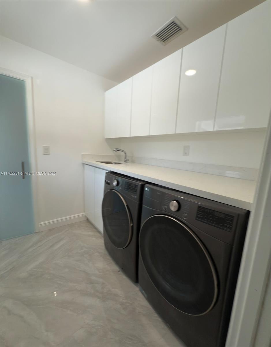 16911 Southwest 66th Street Southwest Ranches, FL 33331 - Photo 60 of 70 a utility room with sink dryer and washer