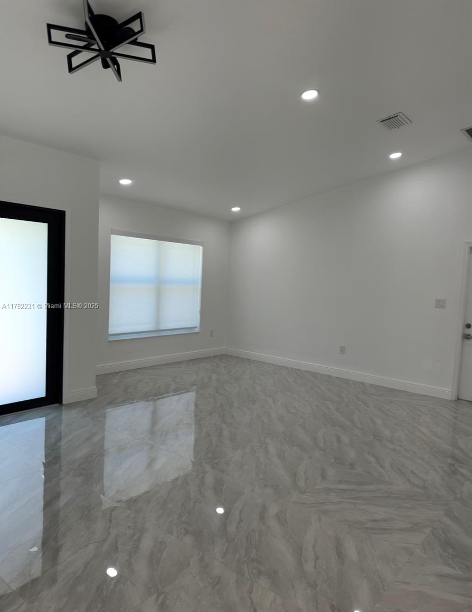 16911 Southwest 66th Street Southwest Ranches, FL 33331 - Photo 6 of 70 an empty room with windows and entrance