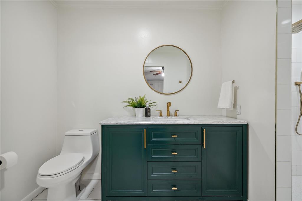 1460 Forrest Drive Canton, TX 75103 - Photo 18 of 36 a bathroom with a toilet a sink and mirror