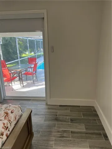 a view of a room that has a bed and a window with the outer view