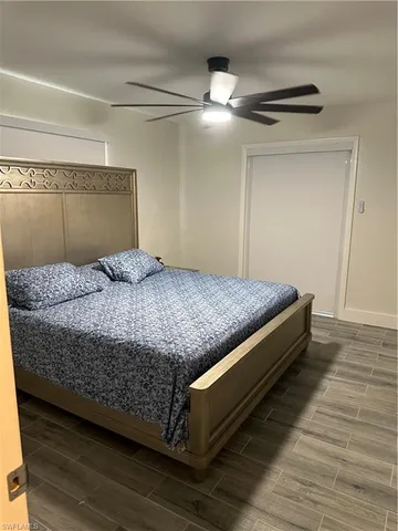 a bedroom with a bed and lamp on desk