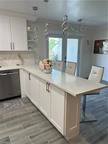 a kitchen with a sink cabinets and wooden floor