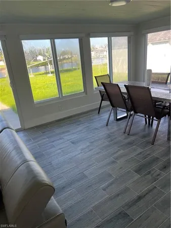 a view of a livingroom with furniture and a window