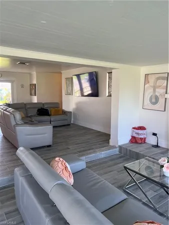 a living room with furniture and painting on the wall