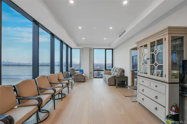 a living room with furniture and two large window