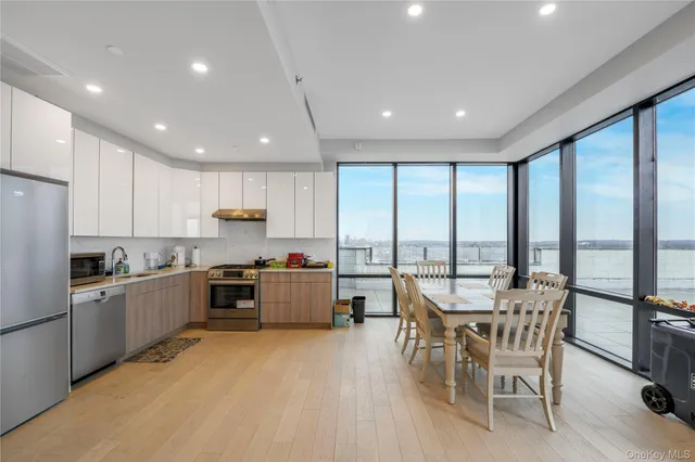a large kitchen with a large window and stainless steel appliances
