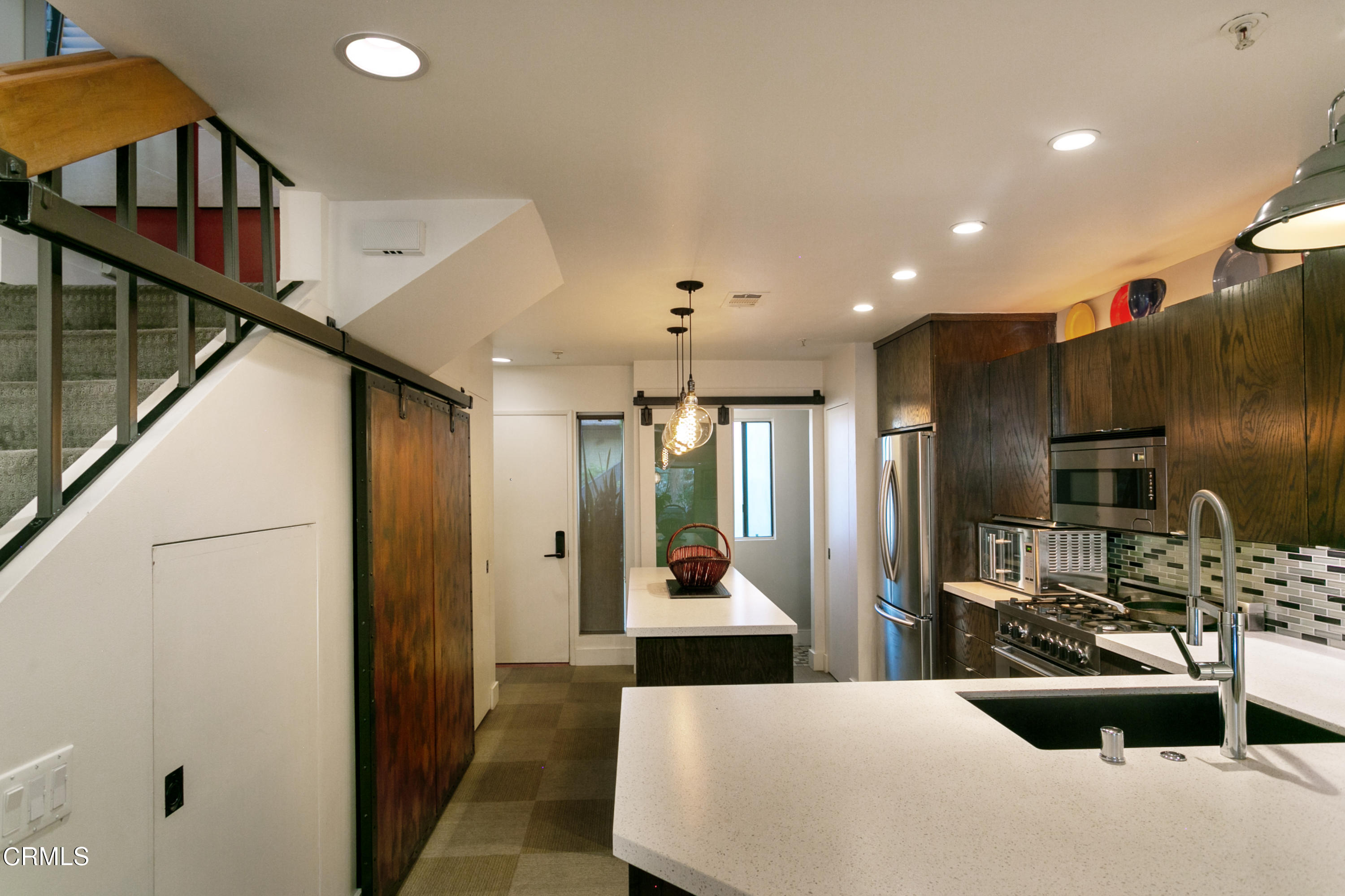 1050 Seco Street, Unit 210 Pasadena, CA 91103 - Photo 2 of 13 a large kitchen with stainless steel appliances kitchen island a refrigerator and a view of living room