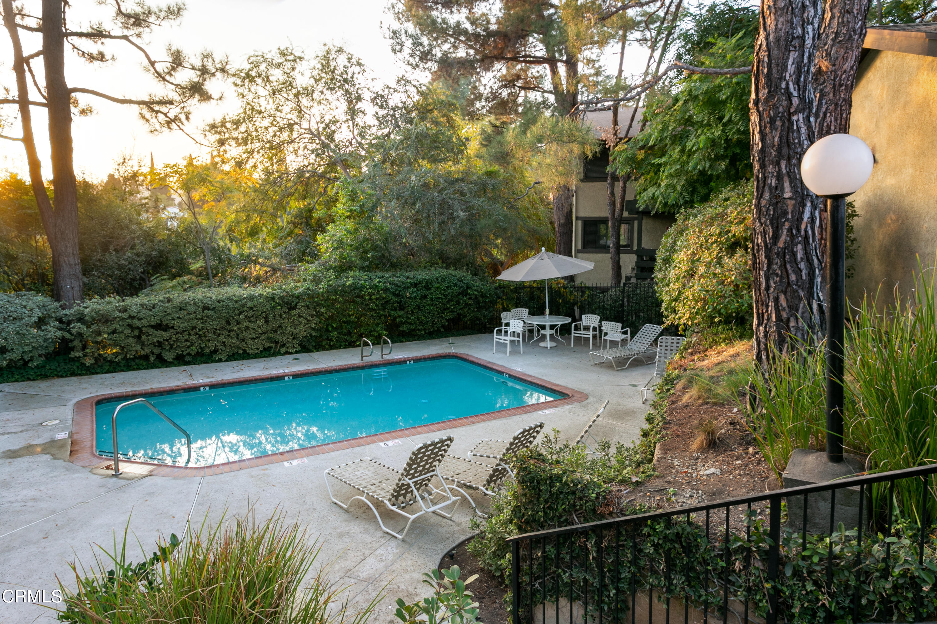 1050 Seco Street, Unit 210 Pasadena, CA 91103 - Photo 9 of 13 a view of a swimming pool with lawn chairs and plants