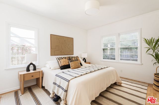 a bedroom with a bed and a large window