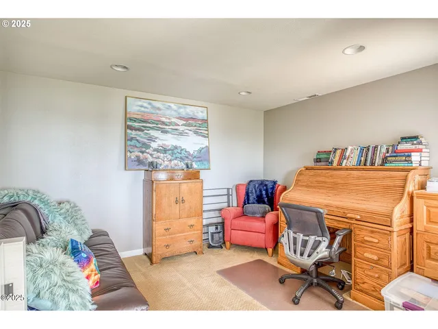 a living room with furniture and view of kitchen