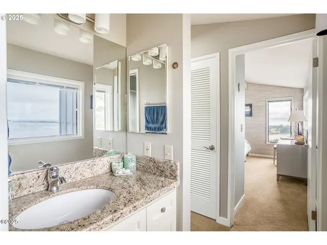 a bedroom with a large bed and a large window