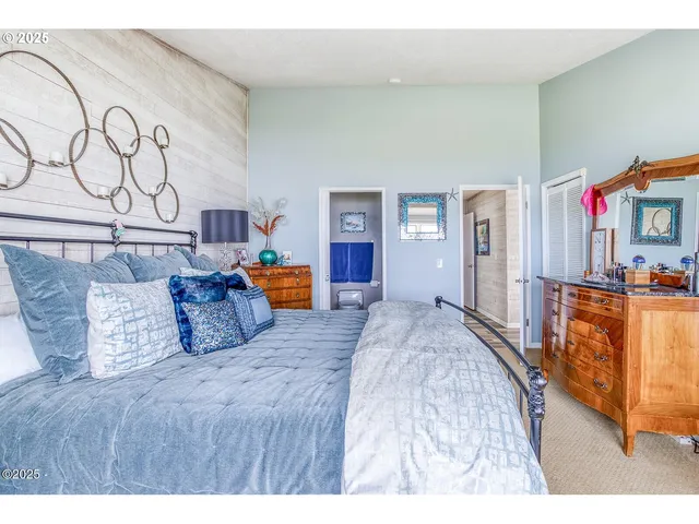 a bedroom with a bed a dresser and of a chandelier