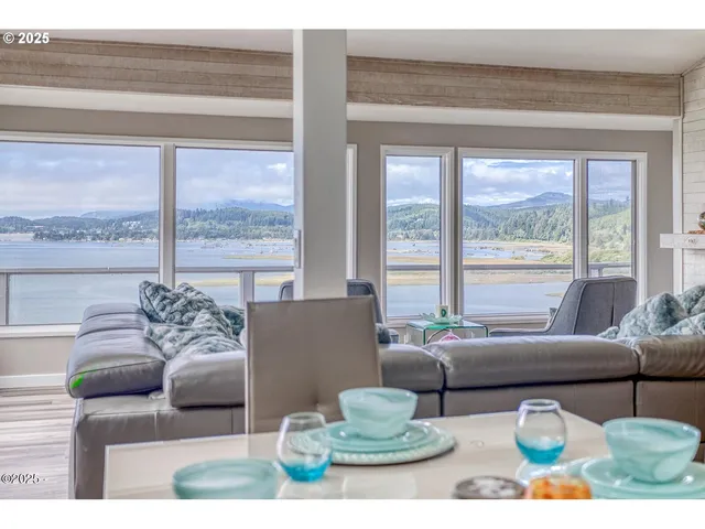 a living room with furniture and large windows