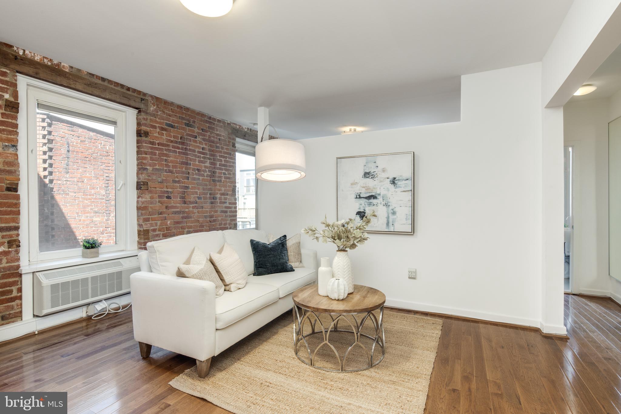 51 Randolph Place Northwest, Unit 303 Washington, DC 20001 - Photo 3 of 14 a living room with furniture and a large window