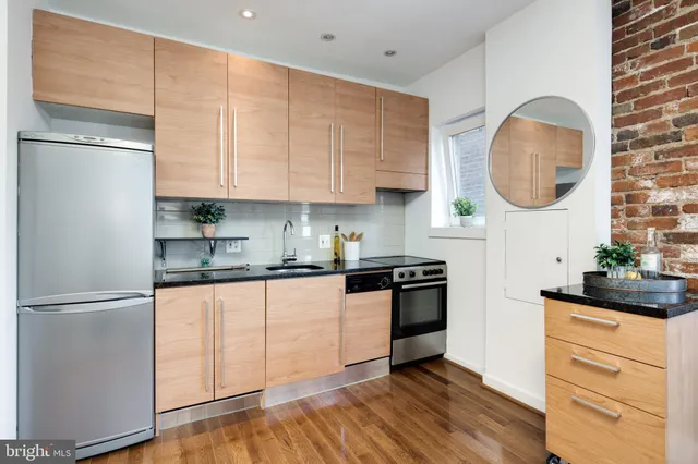 a kitchen with stainless steel appliances granite countertop a refrigerator sink and cabinets