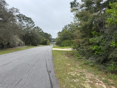 Lot 27 Crescent Road Navarre, FL 32566 - Photo 3 of 24 a view of a big yard with large trees