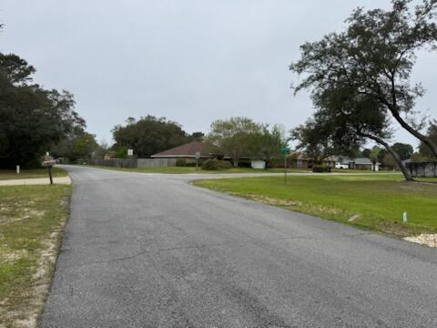Lot 27 Crescent Road Navarre, FL 32566 - Photo 4 of 24 a view of a golf course with a lake
