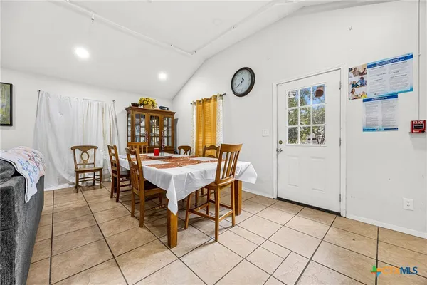 a dining room with furniture and a clock