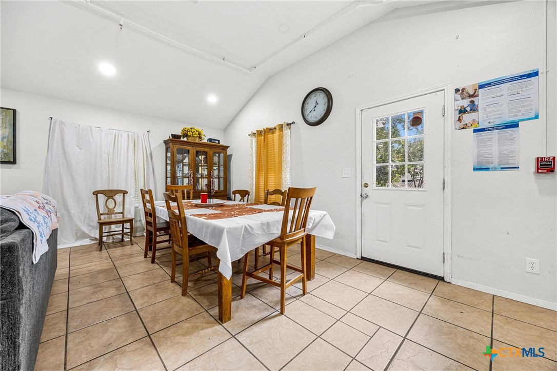 15309 Delahunty Lane Pflugerville, TX 78660 - Photo 11 of 35 a dining room with furniture and a clock