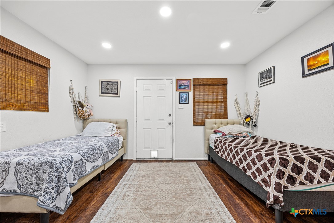 15309 Delahunty Lane Pflugerville, TX 78660 - Photo 14 of 35 a bedroom with a large bed and a window