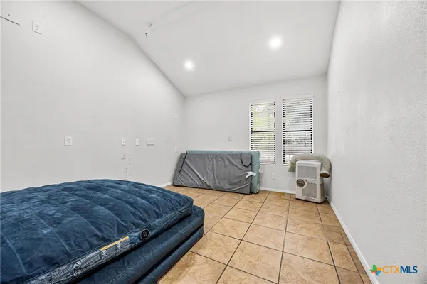 a bedroom with a bed and window