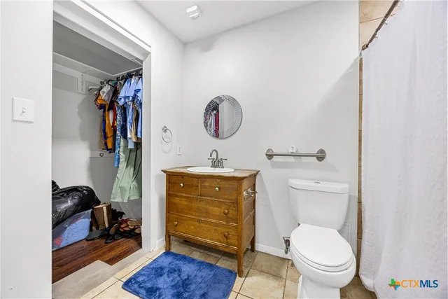 a bathroom with a toilet a sink and a mirror