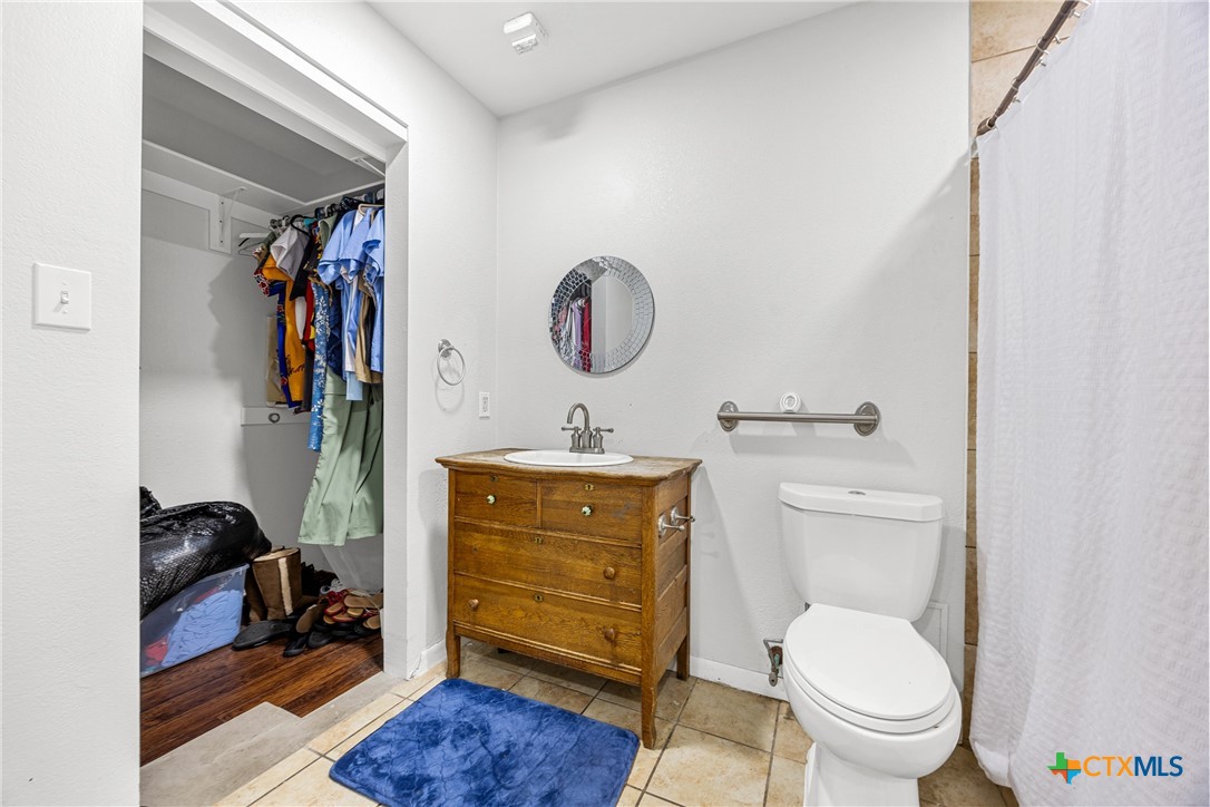 15309 Delahunty Lane Pflugerville, TX 78660 - Photo 18 of 35 a bathroom with a toilet a sink and a mirror